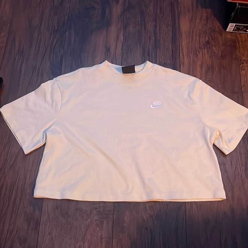 light yellow cropped Nike shirt, in good condition